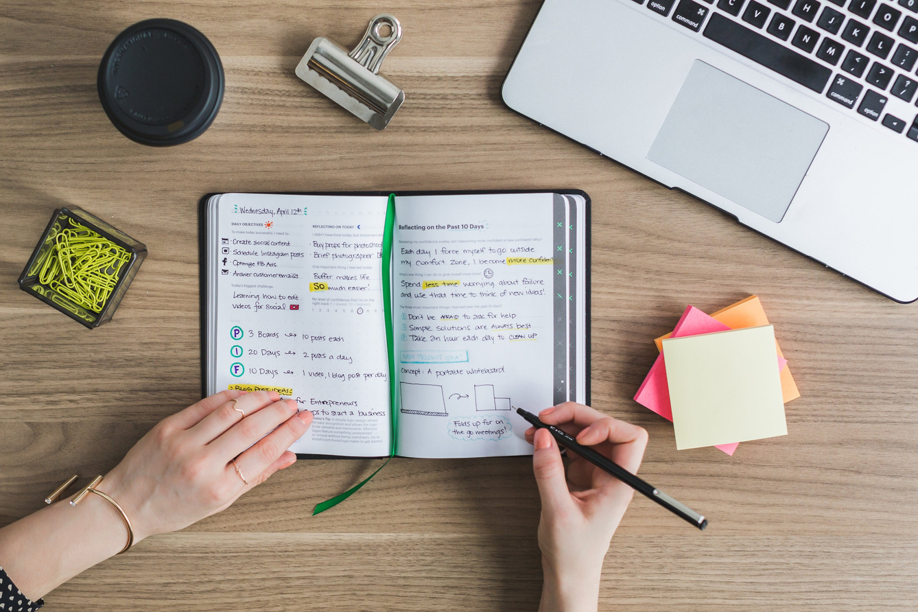 Writing on a Notebook on the Desk